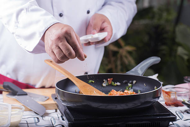 istock Chef putting pepper to the pan 542701856