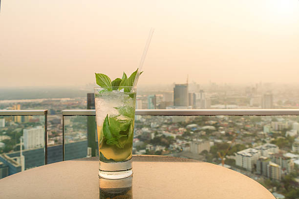 istock Mojito cocktail on table in rooftop bar. 542703832