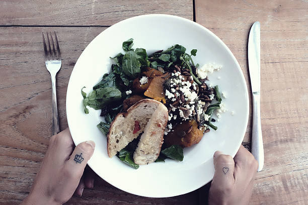 Woman holding a plate of salad