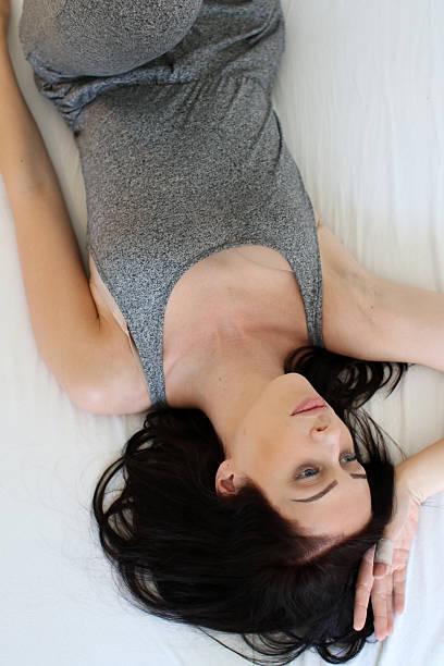 istock Girl posing on bed 542704450