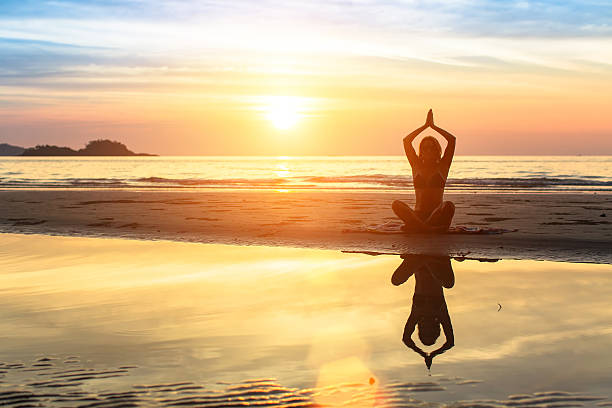 istock Woman doing meditation near the ocean. 542713184