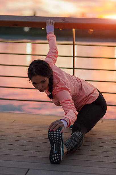 istock Young Woman Stretching Near River. 542717710