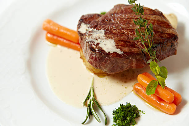 istock Grilled steak with carrots, close up isolated on white 542718438