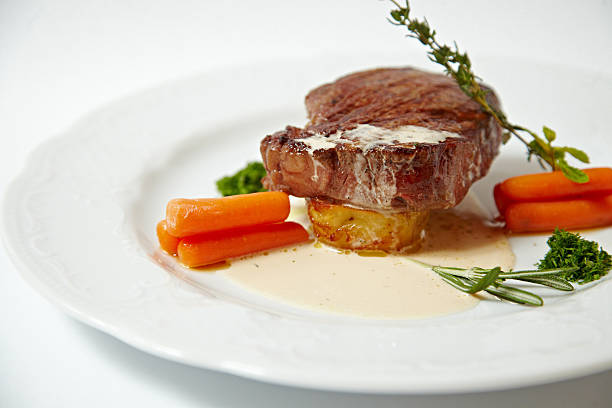 istock Grilled steak with carrots, close up isolated on white 542718472