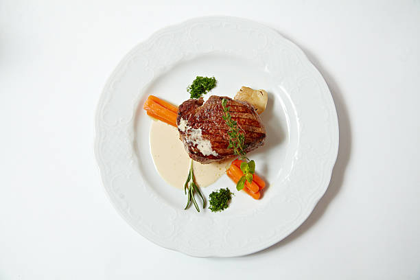 istock Grilled steak with carrots, close up isolated on white 542718498