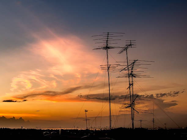 istock Television antenna on rooftop with twilight time 542720838
