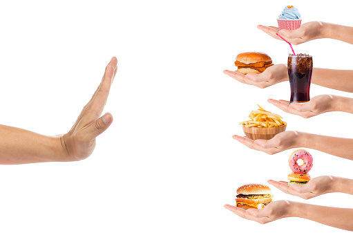 Hand refusing junk food or fast food with white background