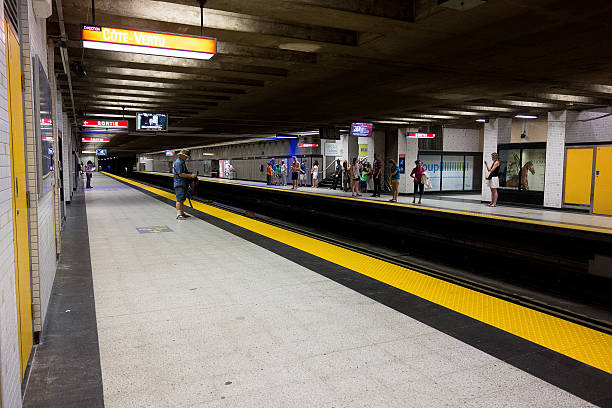 People on Place d'Armes subway platform Montreal, Province of Quebec, Canada - June 25, 2016: People waiting for a train on Place d'Armes subway platform. place darmes montreal stock pictures, royalty-free photos & images