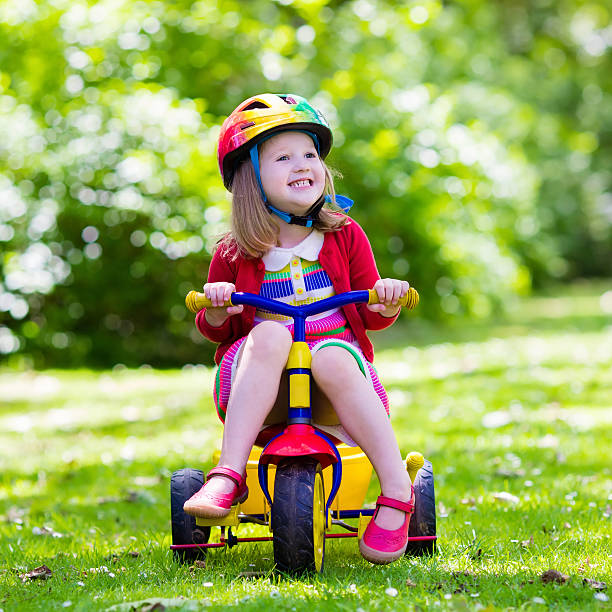 istock Cute little girl riding a tricycle 542727190