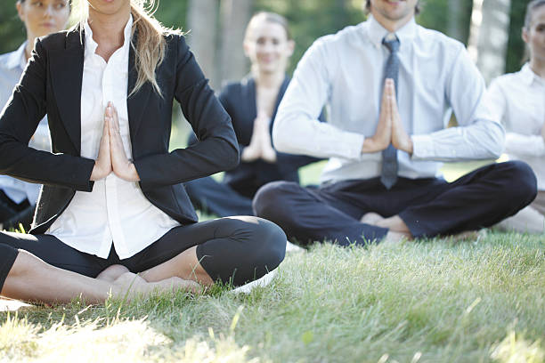 Business people practicing yoga stock photo