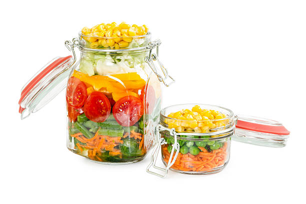 istock Two glass jars with clips with colorful vegetables 542792386