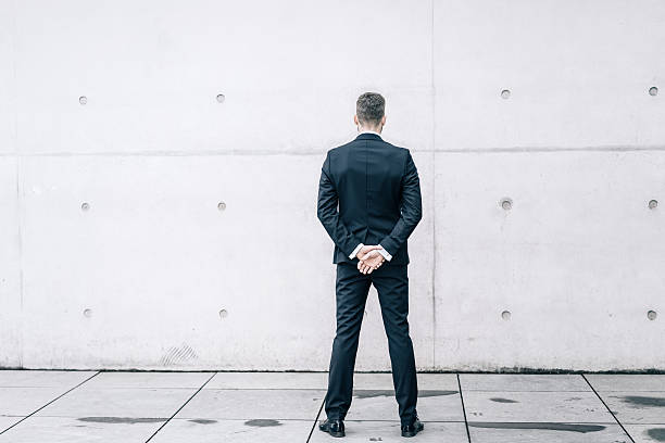 istock Businessman in front of a concrete wall 542792422