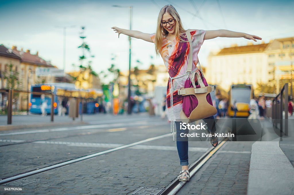 At the tram station Playful young woman is at the tram station Balance Stock Photo