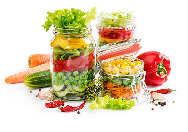 istock Colorful vegetables in glass jars 542792616