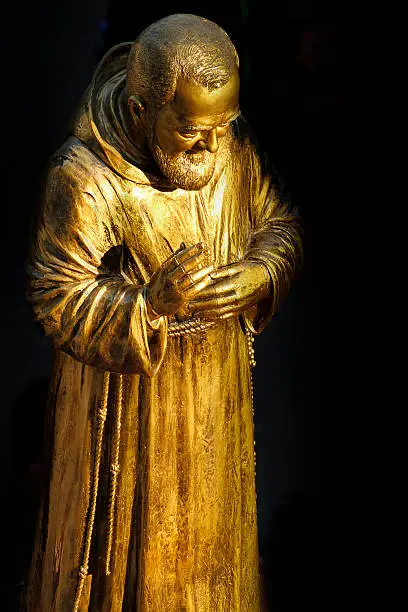 A golden statue of the Saint Padre Pio of Pietrelcina.