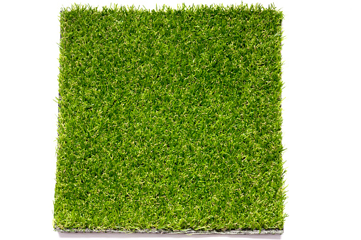 Green artificial grass plate background