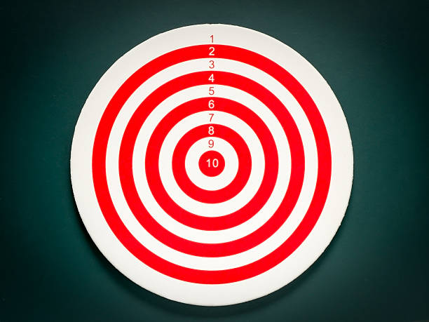 Classic dart target board. Red white dartboard on black background.