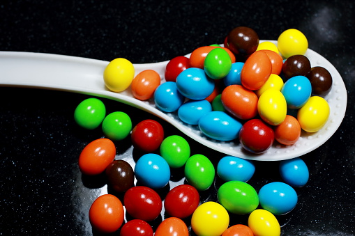 Rainbow candy coated chocolate on the Black background