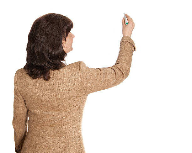 istock Mature age good looking woman writing on  white board 542797014