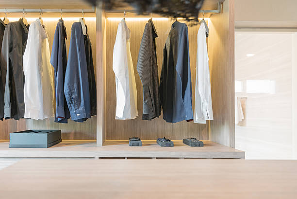 istock clothes hanging in wooden walk in closet 542797702