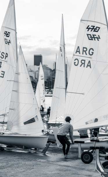 Rio de Janeiro, Brazil - June 25, 2016: Argentinian sailor pulling his 470 dinghy sailboat out of the water.