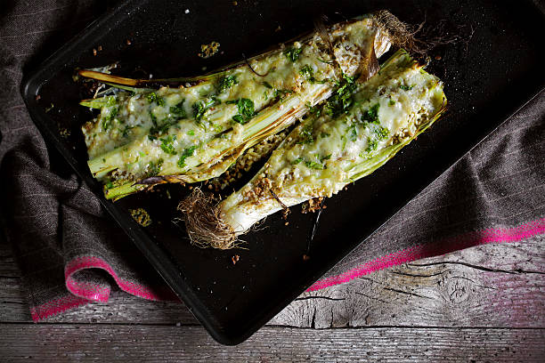 Baked leeks with provolone italian cheese and parsley stock photo