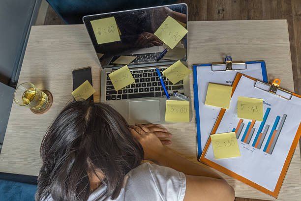 istock Young Asian employee feels tired after working many hours 542803308