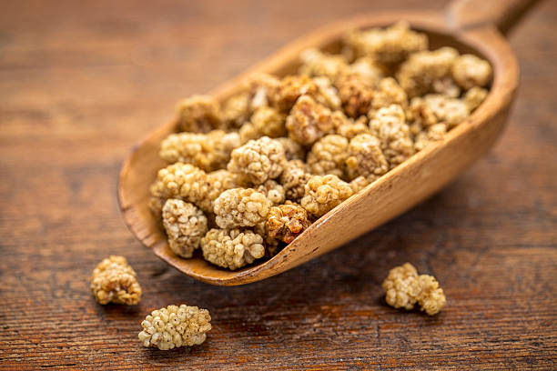 istock scoop of dried white mulberries 542804406