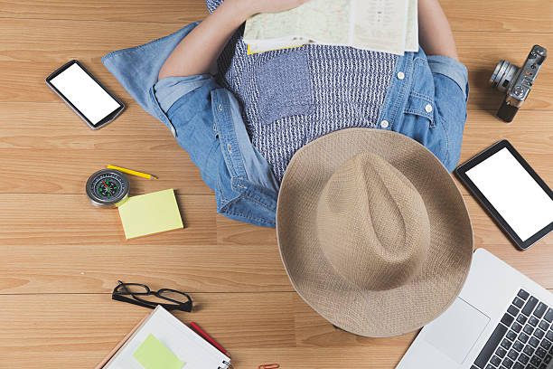 istock woman lying on floor with hat, mobile phone, notebook 542805502