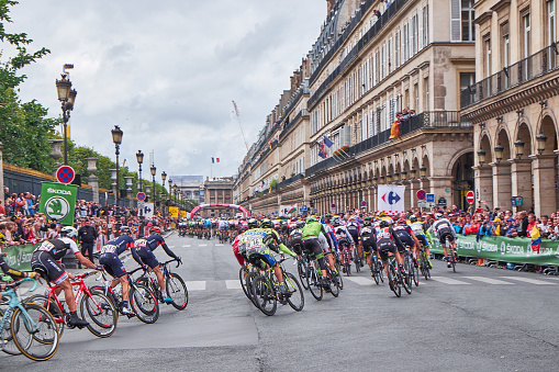 Paris, France - July 26, 2015: the Tour de France peloton on the final stage on the road Rue de Rivoli along the tuileri Garden in Paris