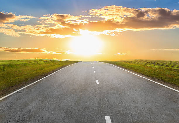 istock sunset over the country highway 542807644