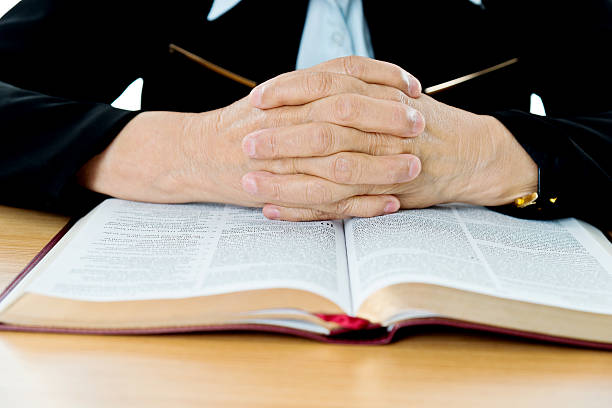 istock Senior woman hands clasped on bible book 542809216