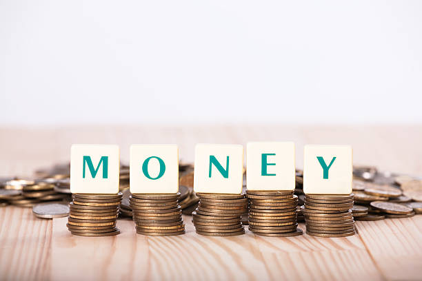 istock Generic tiles money coins light natural wooden abstract 542813604