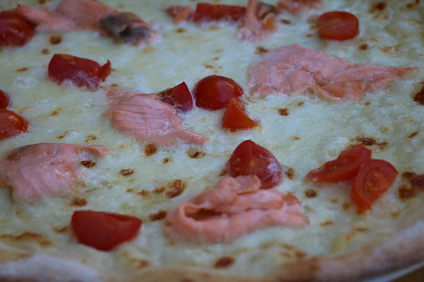 istock pizza with salmon and cherry tomatoes 542815844