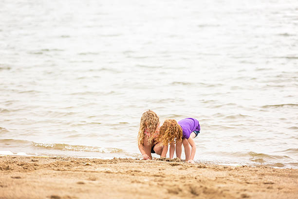 istock Two Young Girls Playing At Beach 542816060