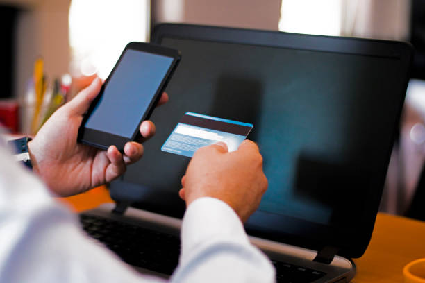 istock Man with mobile phone and credit card 542816444