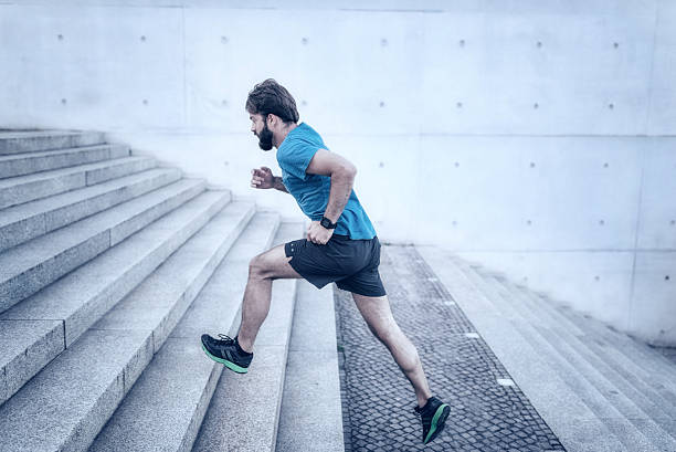 istock bearded sportsman running up stone stairway 542817148