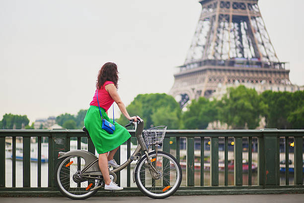 istock Young woman riding a bicycle in Paris 542818912