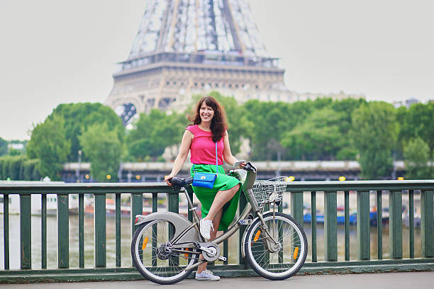 istock Young woman riding a bicycle in Paris 542818968