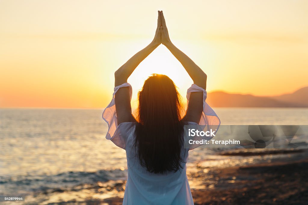 Young woman practicing morning yoga in nature at the beach Active Lifestyle Stock Photo