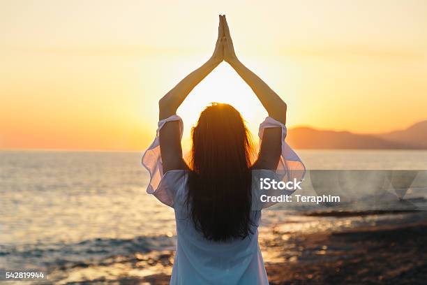 Young Woman Practicing Morning Yoga In Nature At The Beach Stock Photo - Download Image Now