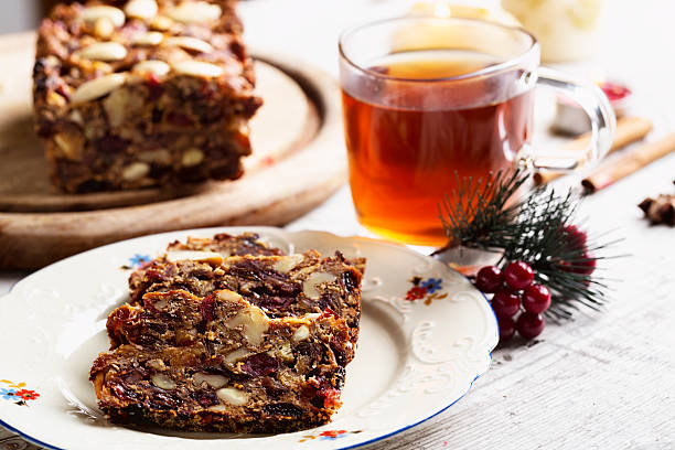 homemade bread or cake made from dried fruit, cut in slices with a cup of star anise and cinnamon flavoured tea. special food made during christmas time in Germany, Austria and Switzerland, it is called Fruechtebrot