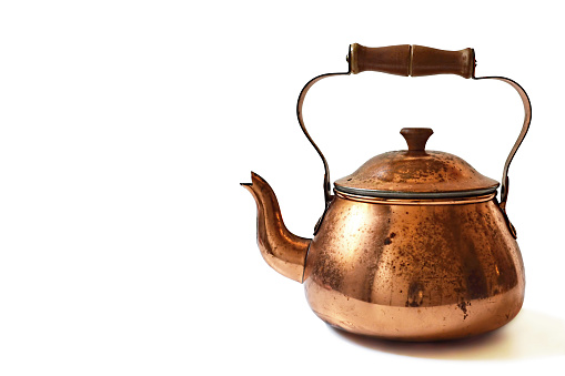 Old copper teapot isolated on white background
