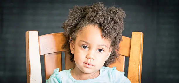 African American young girl/child with natural hair pose sitting