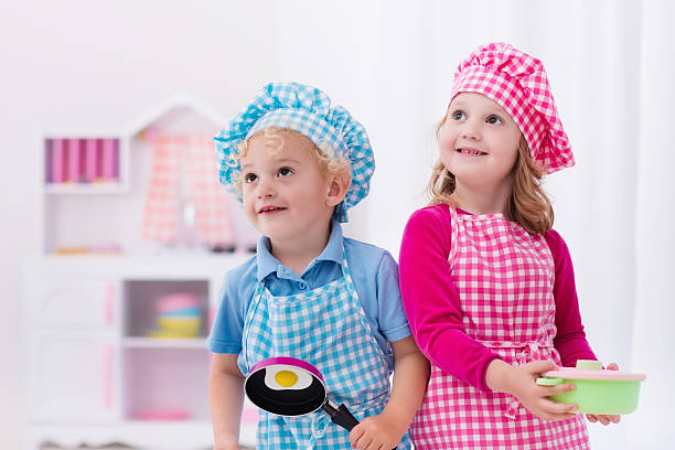 istock Kids cooking fried eggs in toy kitchen 542822978