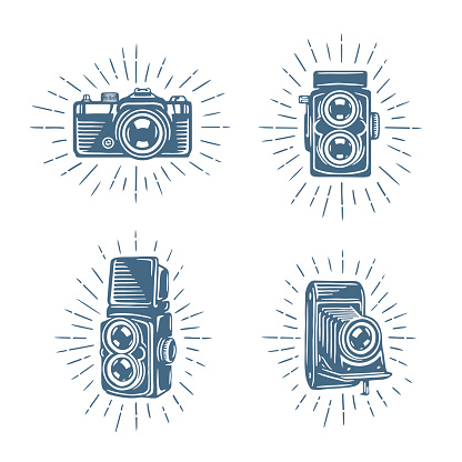 Retro photo cameras set. Design elements for photography related advertising, t-shirt prints, labels, badges, posters. Signs for photographer logo. Hand drawn vector vintage illustration.