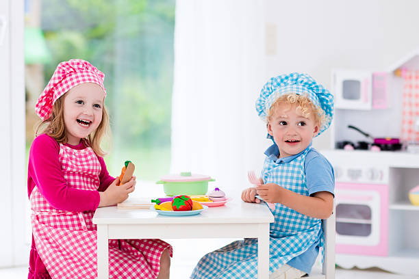 istock Kids cooking with toy kitchen 542823192