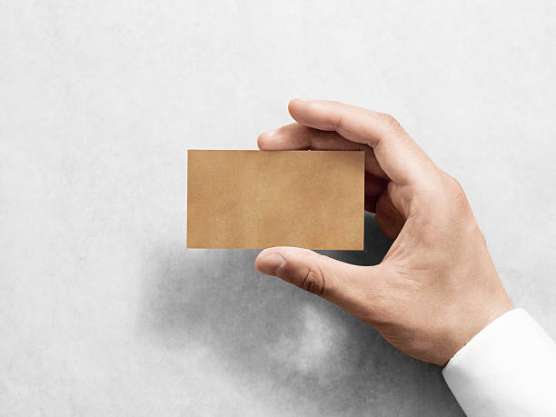 istock Hand hold blank plain kraft business card design mockup. 542824056