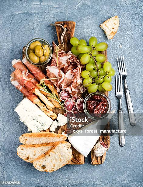 Cheese And Meat Appetizer Selection Prosciutto Di Parma Salami Bread Stock Photo - Download Image Now