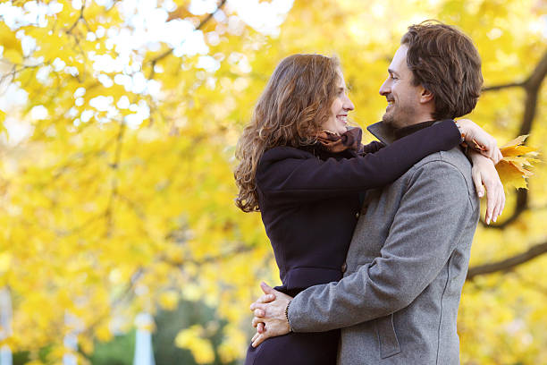 istock Couple hugging in autumn park 542825214